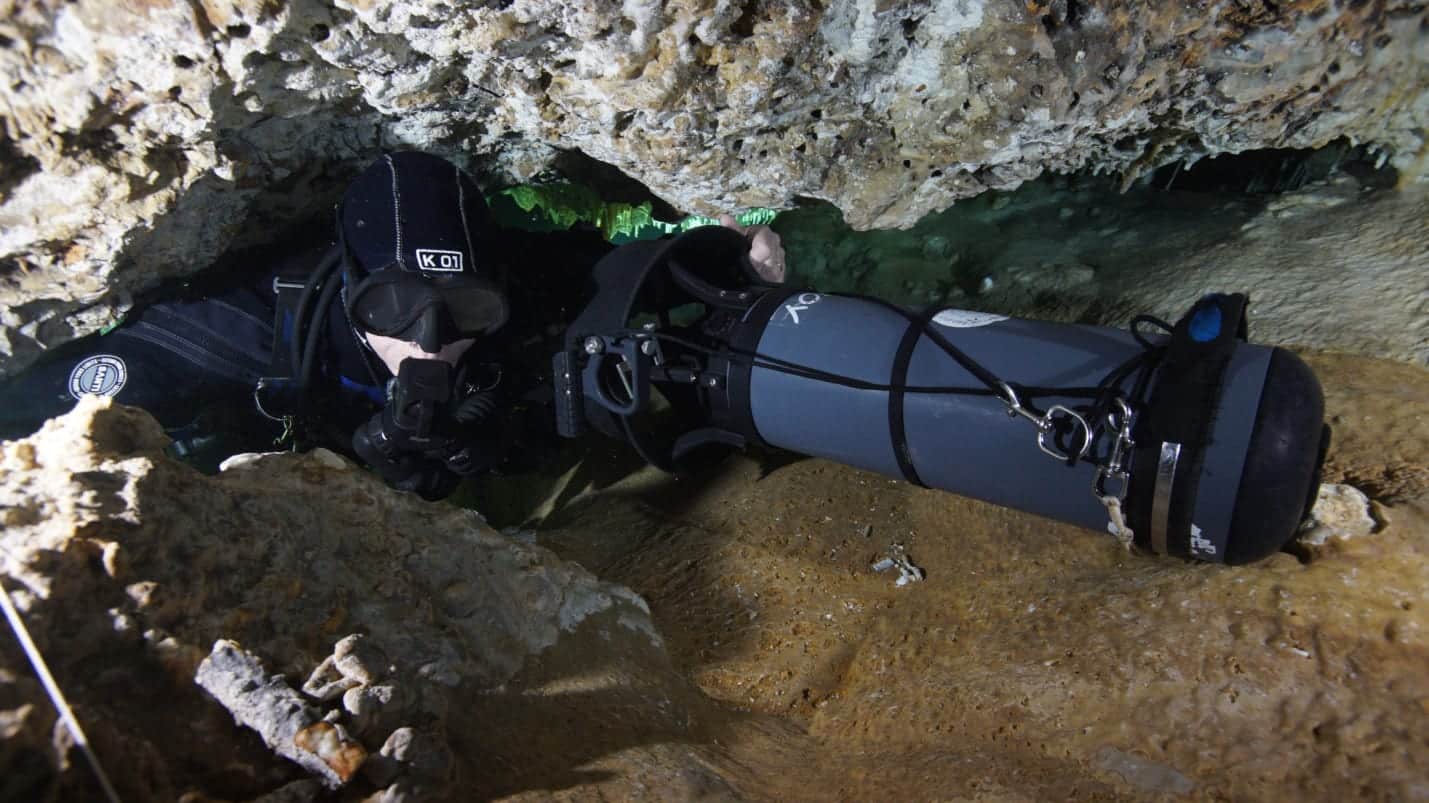 scooter dpv cave diver overcoming a clamp in a cave divers24.co.uk