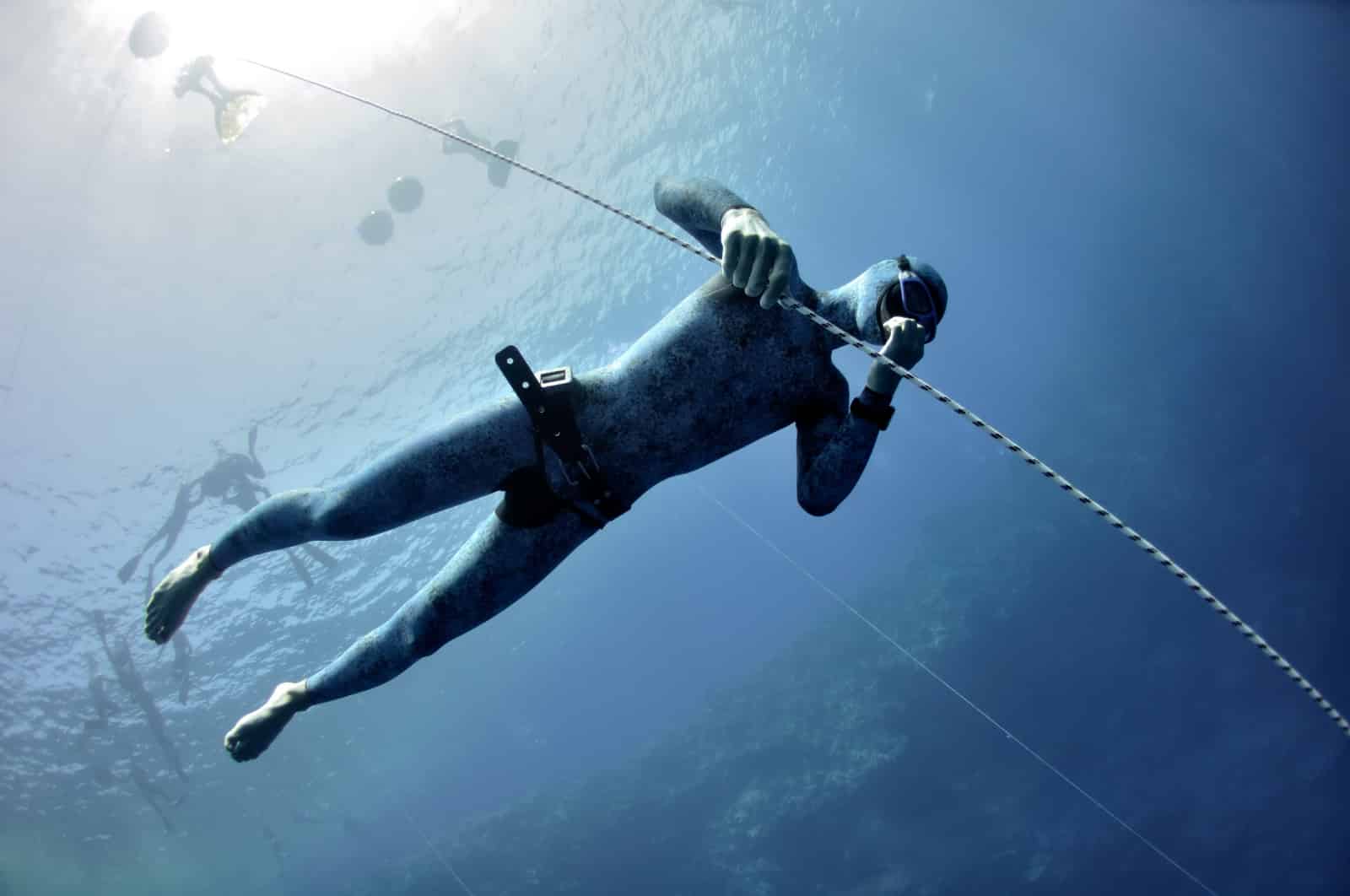 Freediver makes preparation dive near the safety line by breaststroke. Picture shows a part of freediving training session in Blue Hole, Dahab, Egypt