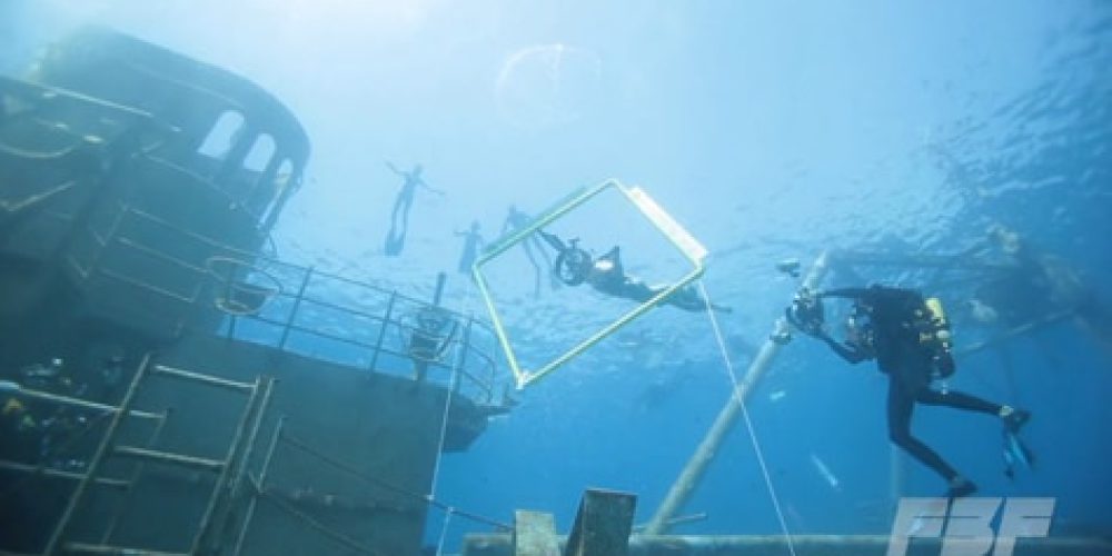 Scooter freedivers race on the wreck of the USS Kittiewake